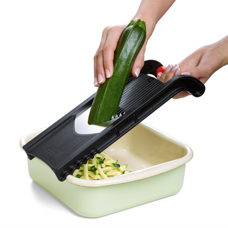 Coupe-légumes avec support pour restes de légumes